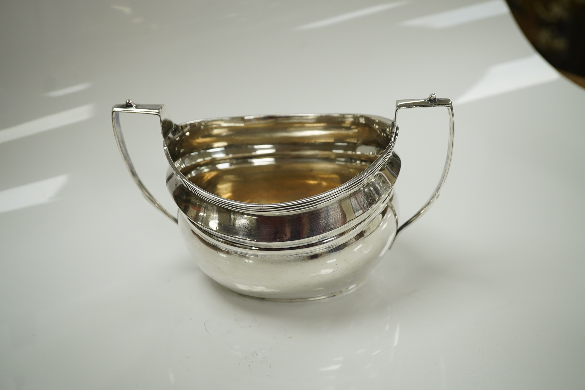 An Edwardian silver teapot and two handled sugar bowl by Charles Stuart Harris & Sons, London 1907, gross weight 23.4oz. Condition - poor to fair